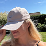 Wiild Swimwear Mahua Cap in beige color  viewed from the side on model