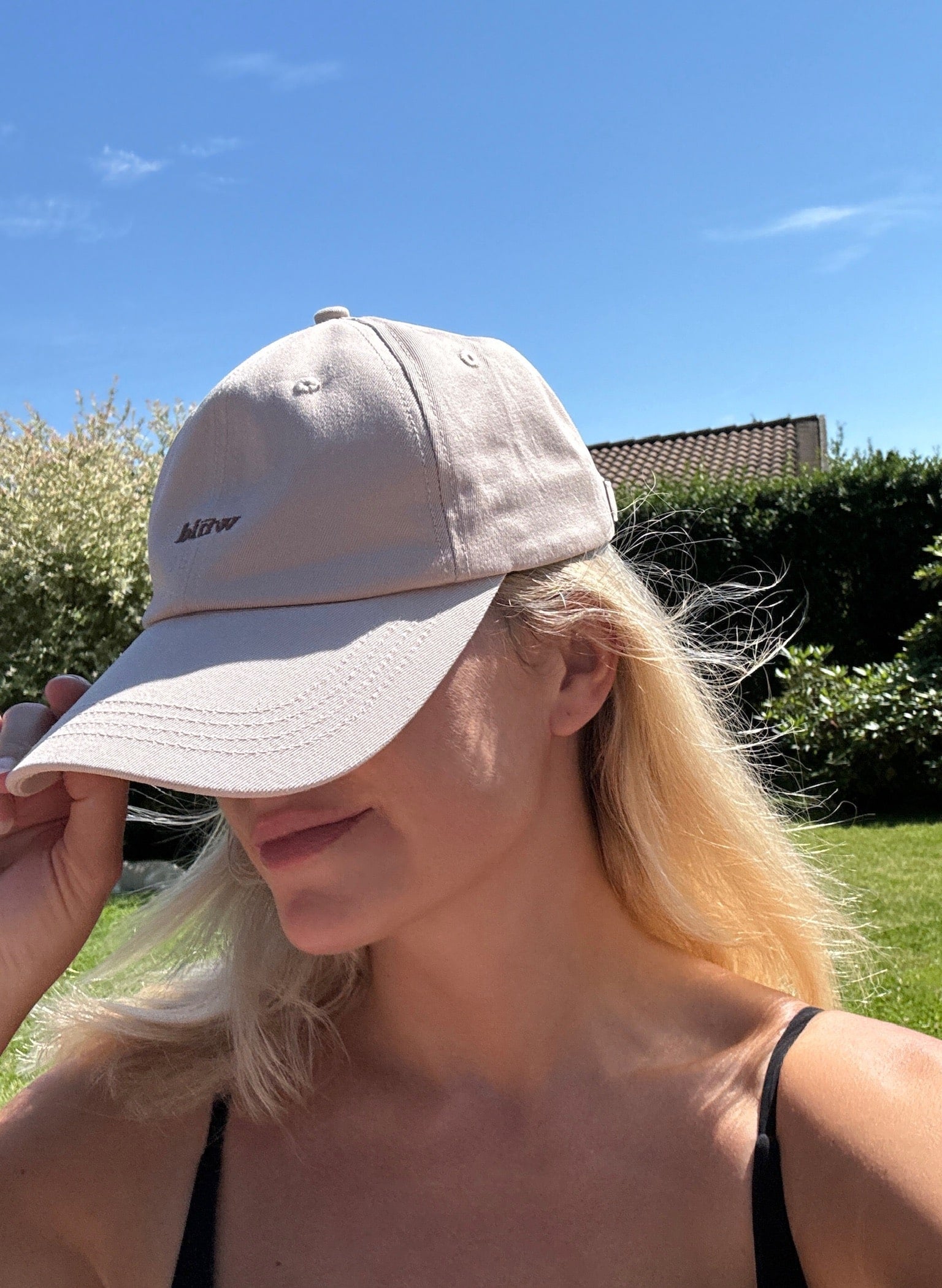 Wiild Swimwear Mahua Cap in beige color  viewed from the side on model